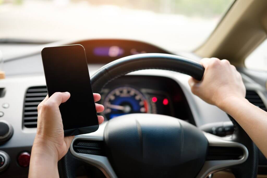 driver holding cell phone